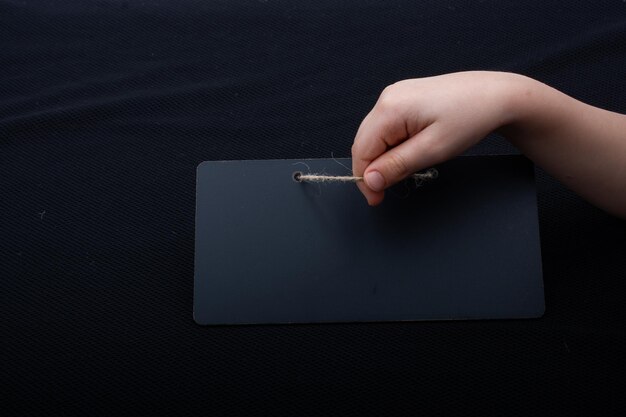 Rectangular shaped black notice board in hand