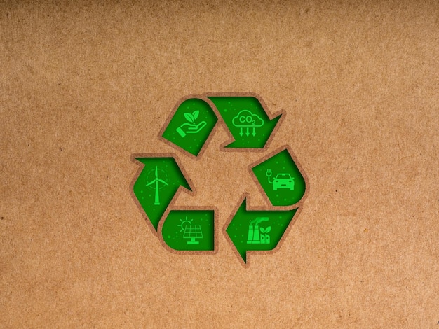 Recycle reduce and reuse save our earth concepts Big green recycle symbol decoration with renewable energy and environment care icon on brown kraft paper or cardboard background minimal style