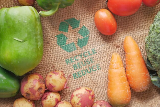 Recycled arrows sign on a shopping bag with vegetable