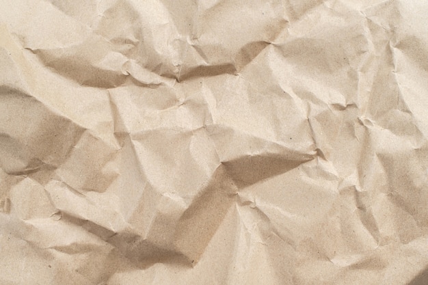 Recycled brown creased paper background from a paper packing. Crumpled brown paper texture concept