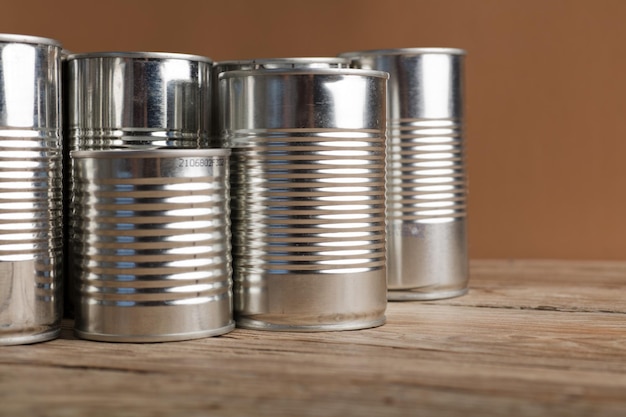 recycled cans reused on a table with a brown background top view space for text