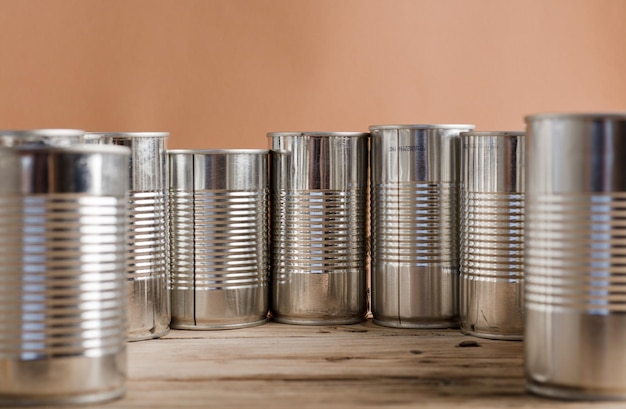 recycled cans reused on a table with a brown background top view space for text