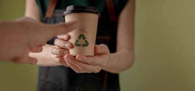 Recycled Packaging Concept Barista Giving a Hot Cup of Coffee to customer Zero Waste Materials Environment Care Reuse Renewable for Sustainable Lifestyle POV shot