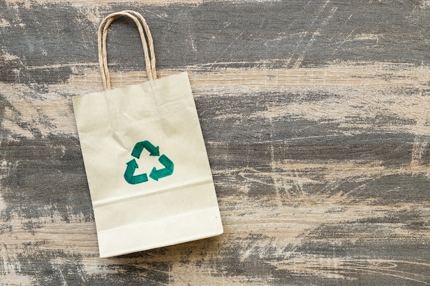 Recycled paper bag on old wood background, Eco friendly and sustainability concept