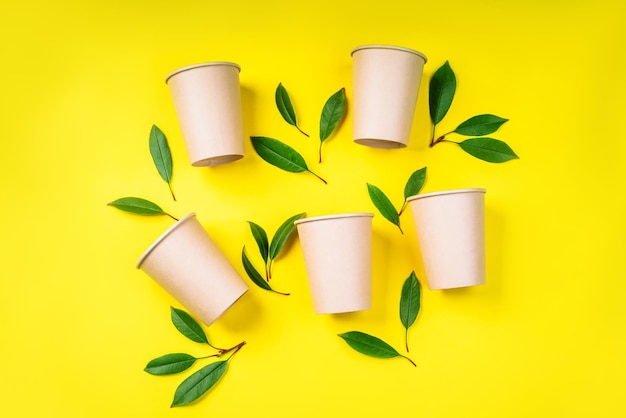 Recycled paper cups Zero waste conceptDisposable paper cups on a yellow background