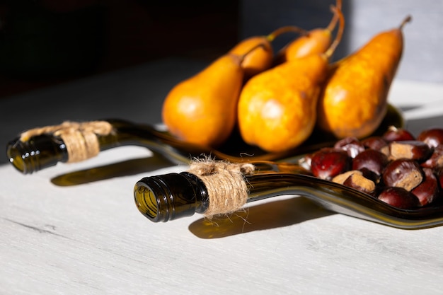 Recycled wine bottle plate with pear and edible chestnut