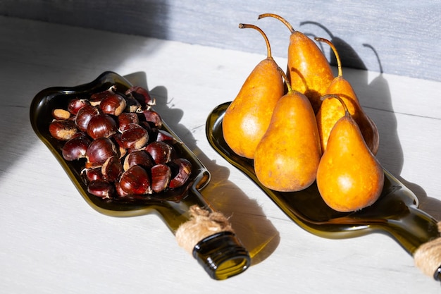 Recycled wine bottle plate with pear and edible chestnut