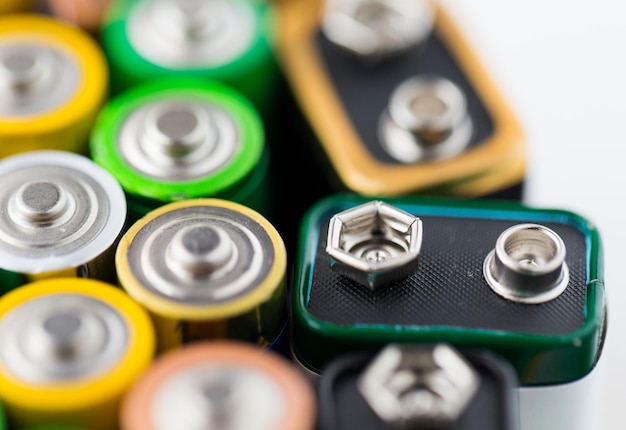 recycling, energy, power, environment and ecology concept - close up of alkaline batteries heap