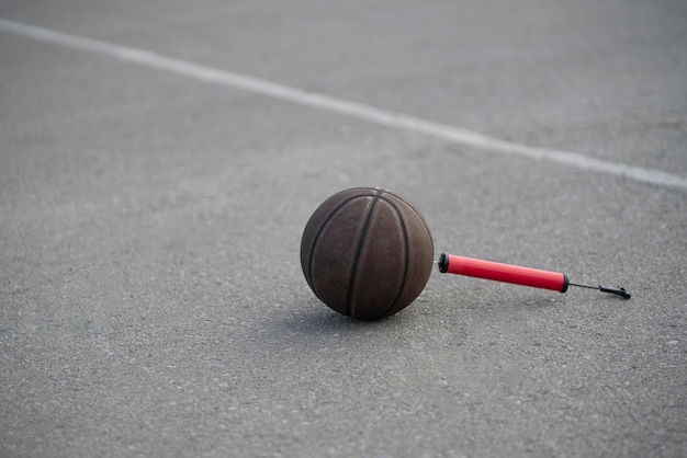 A red air pump for sport game on the ground