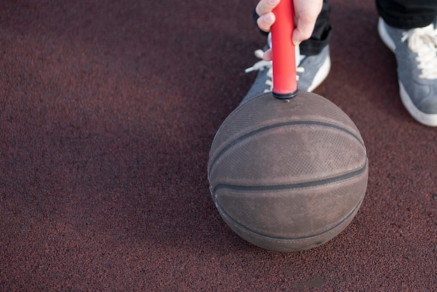 A red air pump for sport game on the ground