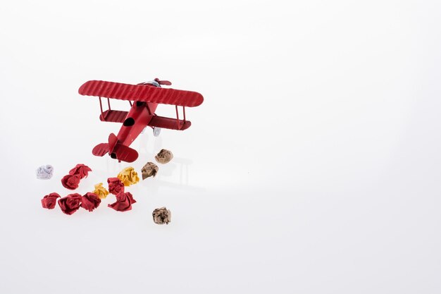 Red airplane and crumpled paper