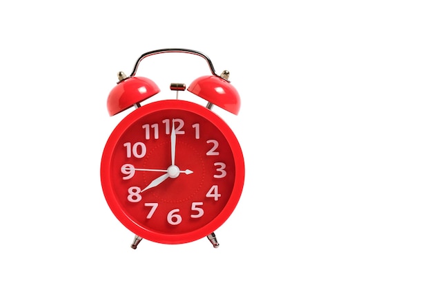 Red alarm clock isolated on a white background shows eight clock in morning.