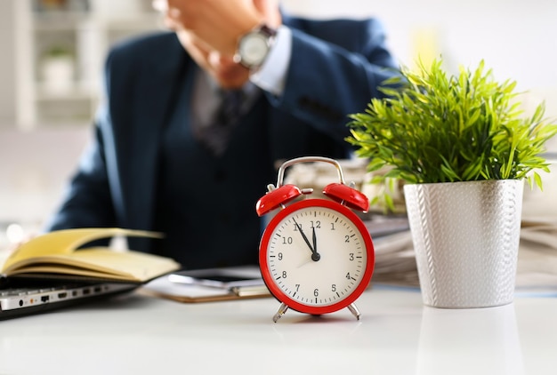 Red alarm clock shows late time closeup