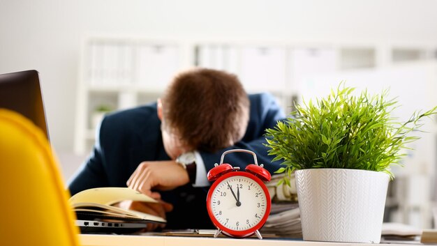 Red alarm clock shows late time closeup