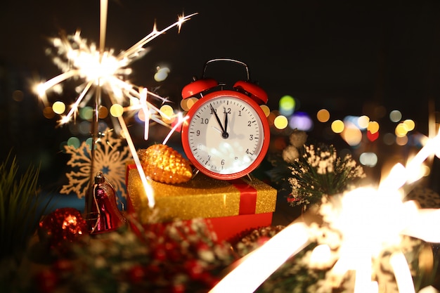 Red alarm clock with christmas gifts 