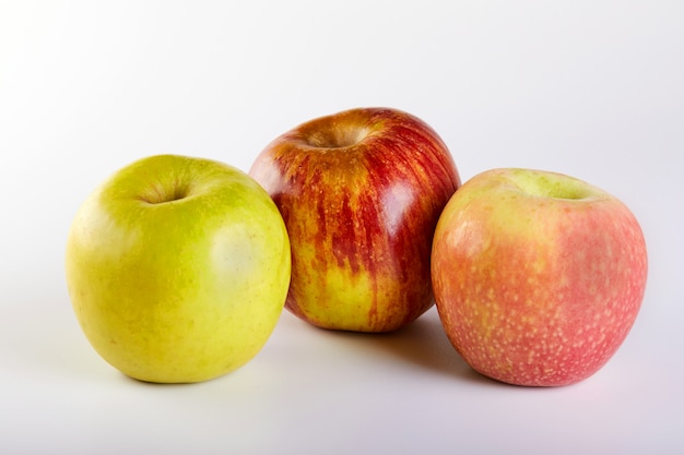 Red apple, green and pink apples isolated on white