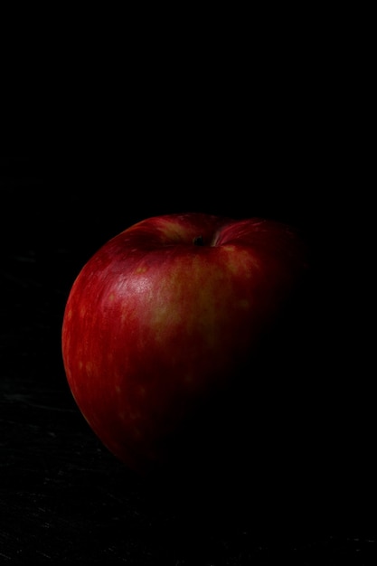 Red apple isolated on the black wooden background