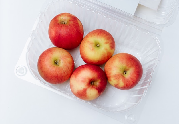 Red apple in plastic box