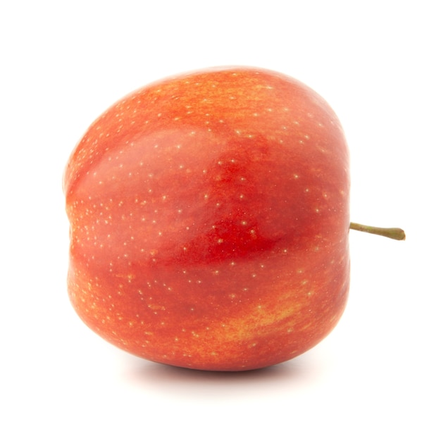 Red apple on a white surface with a shadow.