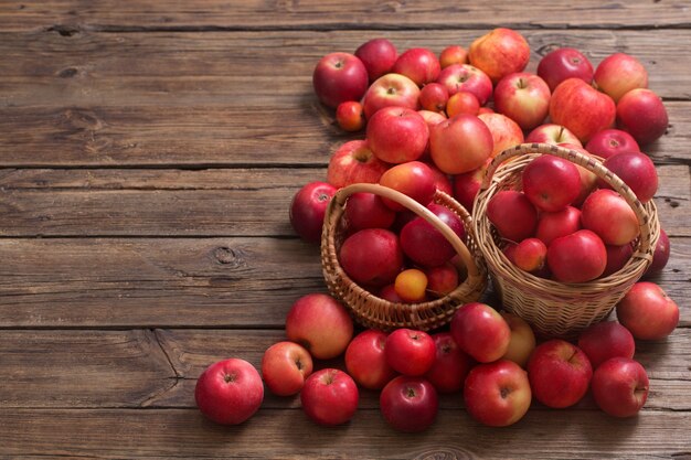 Red apples on old wooden surface