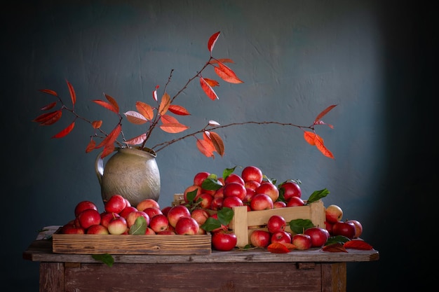 Red apples on old wooden table on background blue wall