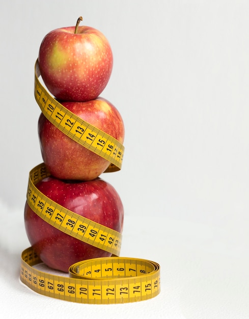 Red apples with a centimeter tape