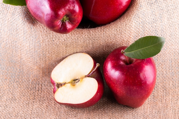 Red apples with leaves on the table