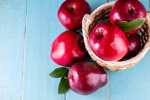 Red apples with leaves on the table