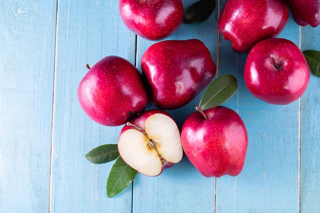 Red apples with leaves on the table