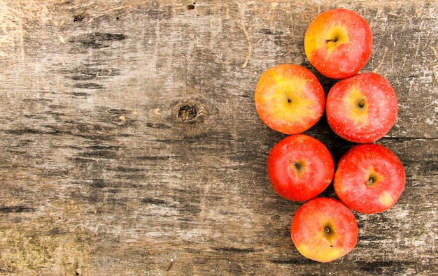 Red apples on wooden background