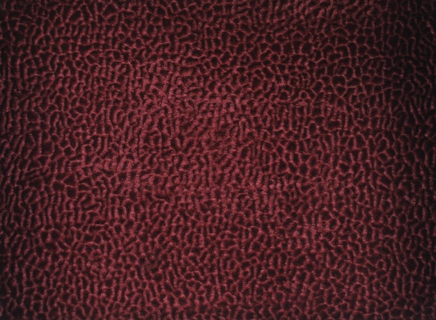 A red background with a pattern of leopard skin.