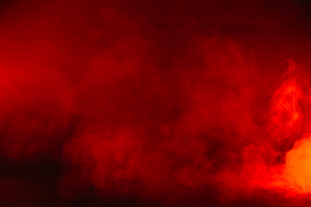 a red background with smoke in the middle