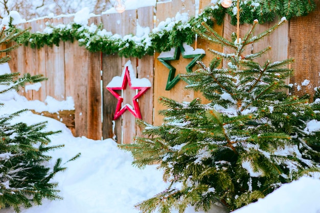 red backyard porch of the rural house decorated for Christmas, winter still life, New Year vacation