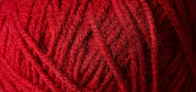 Red ball of yarn all over background, closeup