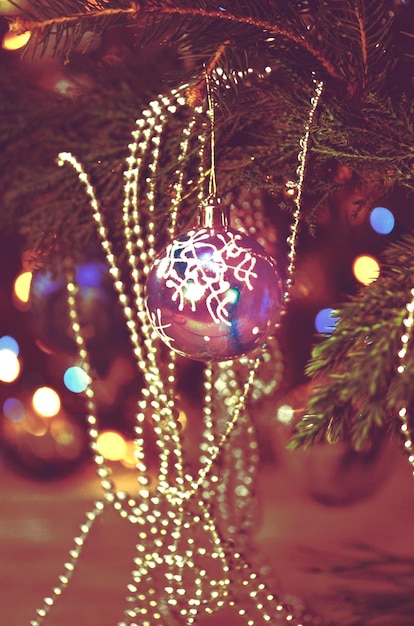 Red bauble on Christmas tree Decorated Christmas tree Ball on Christmas tree