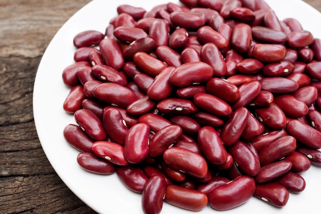 Red bean kidney in white dish on old wooden background