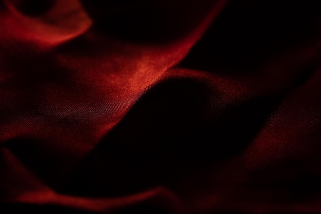 Red bed linen gradient texture blurred curve style of abstract luxury fabricWrinkled bed linen and red shadowsbackground cloth detail