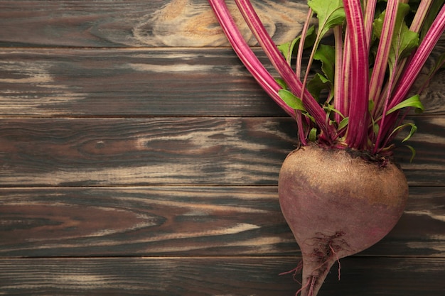 Red Beetroot with green leaves on brown background Organic Beetroot