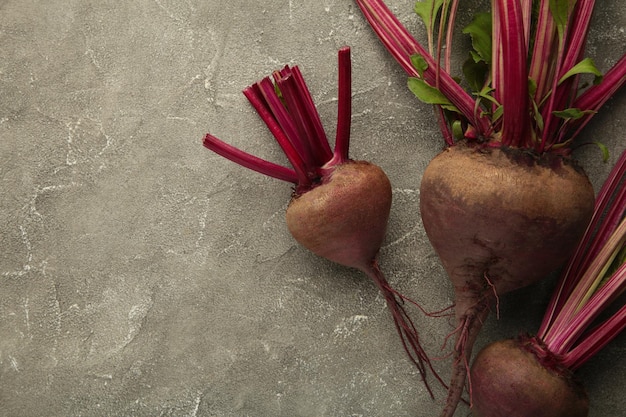 Red Beetroot with green leaves on grey background Organic Beetroot