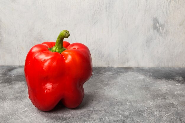 Red bell pepper on gray background. Copy space. Food background