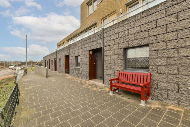 A red bench sitting outside of a building