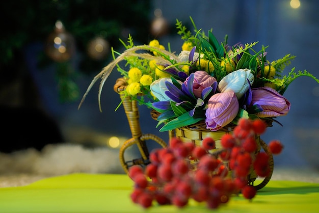 Red berries on a bright colored background and a bouquet of flowers a symbol of winter and Christmas