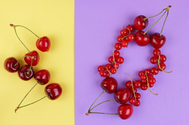 Red berries on a pinkyellow background Closeup of sweet berries Healthy food concept