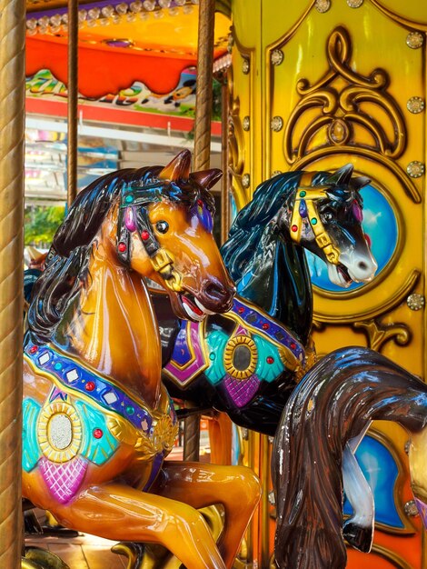 Red and black horse carousel in the park