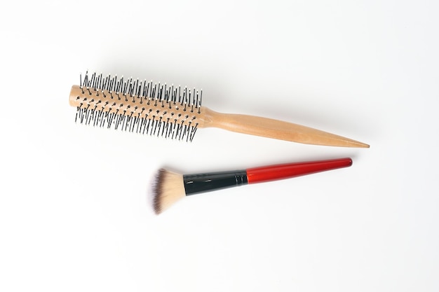 Photo red black makeup wooden hair brush comb beauty accessories on white background