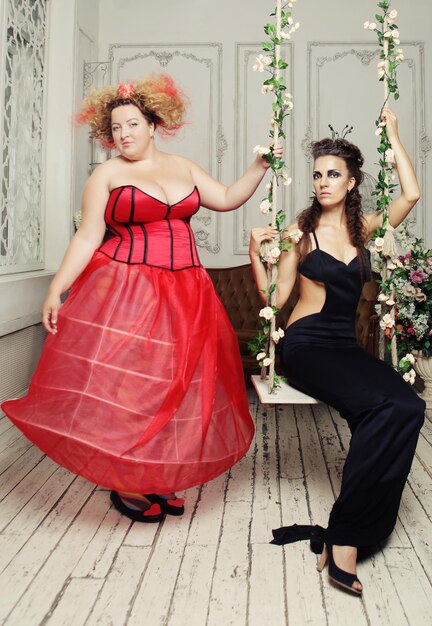 Red and Black Queens posing with swing