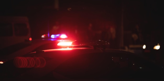 Red and blue light flasher Police car at night time in the city