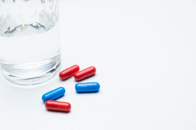 Red and blue medicines on a white background.