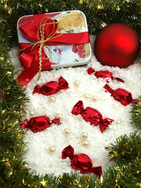 A red bow is tied to a gift box with a red ribbon that says'candy'on it