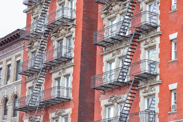 Red brick facade, and fire stairs. Harlem, NYC.